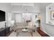 Comfortable living room with stylish decor, a staircase, and ample natural light at 6923 Stones Throw N Cir # 4205, St Petersburg, FL 33710