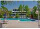 Community pool surrounded by lounge chairs and umbrellas for enjoying the outdoors at 6923 Stones Throw N Cir # 4205, St Petersburg, FL 33710