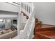 Elegant staircase with wooden steps and white railings, connecting living spaces within the home at 6923 Stones Throw N Cir # 4205, St Petersburg, FL 33710