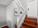 Staircase with wooden stairs and white railing leading to the upper level at 6923 Stones Throw N Cir # 4205, St Petersburg, FL 33710
