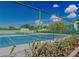 View of tennis court with green and blue surface, framed by lush greenery at 6923 Stones Throw N Cir # 4205, St Petersburg, FL 33710