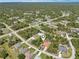 A birds-eye-view of a home in a vibrant neighborhood nestled amidst lush greenery and quiet residential streets at 6968 De Brita Rd, North Port, FL 34291