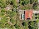 From above, a terracotta roofed home, screened pool, and verdant surroundings define a peaceful residential setting at 6968 De Brita Rd, North Port, FL 34291