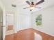 This bedroom has wood flooring, a ceiling fan, and lots of closet space at 6968 De Brita Rd, North Port, FL 34291