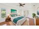 Stylish bedroom features a tray ceiling, wood floors, and access to the outdoors through french doors at 6968 De Brita Rd, North Port, FL 34291