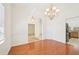 Bright dining room featuring wood floors, elegant chandelier, and arched doorways at 6968 De Brita Rd, North Port, FL 34291