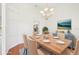 Formal dining room with wood table, upholstered chairs, decorative chandelier, and wood flooring at 6968 De Brita Rd, North Port, FL 34291