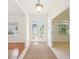 Inviting home foyer with decorative glass double doors, tile flooring, and a neutral-toned rug at 6968 De Brita Rd, North Port, FL 34291