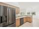 Spacious kitchen with stainless steel refrigerator and a breakfast bar with views of the backyard at 6968 De Brita Rd, North Port, FL 34291