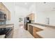 Well-lit kitchen showcasing sleek appliances, light wood cabinetry, and open design at 6968 De Brita Rd, North Port, FL 34291