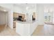 Open concept kitchen features light wood cabinetry, a breakfast bar, and modern appliances at 6968 De Brita Rd, North Port, FL 34291