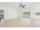Bright living room with tile flooring and sliding glass doors leading to the lanai and pool at 6968 De Brita Rd, North Port, FL 34291