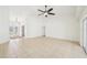 Bright living room features tile flooring, ceiling fan, and sliding glass door to seamlessly blend indoor and outdoor living at 6968 De Brita Rd, North Port, FL 34291