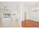 Open floor plan with tile flooring, a ceiling fan, and sliding glass doors leading to the lanai and pool at 6968 De Brita Rd, North Port, FL 34291
