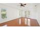 Spacious main bedroom boasts a tray ceiling, wood-look floors, and a double-door entrance to the lanai at 6968 De Brita Rd, North Port, FL 34291