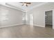 Empty main bedroom features a tray ceiling, large windows, and walk-in closet at 7140 Maysville Ct, Wesley Chapel, FL 33545