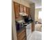 Bright kitchen with wooden cabinets, clean appliances, and functional layout at 7526 Needle Leaf Pl # 30, Tampa, FL 33617