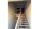Stairwell with multiple apartment doors, featuring sturdy railings and a secure entrance at 7526 Needle Leaf Pl # 30, Tampa, FL 33617
