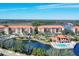 Aerial view showing residences, a pool and clubhouse, and lake views at 7710 Lake Vista Ct # 205, Lakewood Ranch, FL 34202