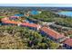 Wide aerial view of the community featuring lakes, trees, and a cluster of buildings at 7710 Lake Vista Ct # 205, Lakewood Ranch, FL 34202