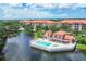 Aerial view featuring a swimming pool on a lake island within the community at 7710 Lake Vista Ct # 205, Lakewood Ranch, FL 34202