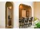 Cozy bar area with counter seating, granite counters, and a view into the kitchenette at 7710 Lake Vista Ct # 205, Lakewood Ranch, FL 34202