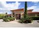 Clubhouse with a red tile roof, manicured landscaping, and a flagpole at 7710 Lake Vista Ct # 205, Lakewood Ranch, FL 34202