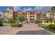 Beautiful condo community featuring lush landscaping and stunning architecture with a brick drive at 7710 Lake Vista Ct # 205, Lakewood Ranch, FL 34202