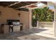 Outdoor grilling area featuring a stainless steel grill, sink, and ample counter space at 7710 Lake Vista Ct # 205, Lakewood Ranch, FL 34202