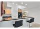 Bright kitchen with breakfast bar, granite countertops, light wood cabinets, and stainless appliances at 7710 Lake Vista Ct # 205, Lakewood Ranch, FL 34202