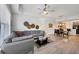 Bright and spacious living room with a large gray sectional, ceiling fan, and modern decor at 7710 Lake Vista Ct # 205, Lakewood Ranch, FL 34202