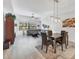 Living and dining room area with gray sectional sofa, dining table, and an outdoor view at 7710 Lake Vista Ct # 205, Lakewood Ranch, FL 34202