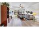 Bright living room with a comfortable gray couch, modern fan, and stylish decor elements at 7710 Lake Vista Ct # 205, Lakewood Ranch, FL 34202
