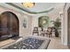 Inviting condo lobby with an elegant rug, seating, and arched doorway, exudes sophistication at 7710 Lake Vista Ct # 205, Lakewood Ranch, FL 34202