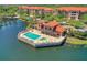 Stunning aerial view of the community pool overlooking the water, surrounded by plenty of lounge seating at 7710 Lake Vista Ct # 205, Lakewood Ranch, FL 34202
