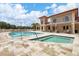 Resort-style community pool and hot tub surrounded by comfortable seating and lush landscaping at 7710 Lake Vista Ct # 205, Lakewood Ranch, FL 34202