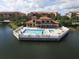 Aerial view of a beautiful community pool overlooking a serene lake at 7710 Lake Vista Ct # 205, Lakewood Ranch, FL 34202