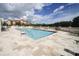 Sparkling community pool with a view of the surrounding buildings and well-manicured grounds at 7710 Lake Vista Ct # 205, Lakewood Ranch, FL 34202