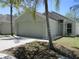 Inviting single-story home featuring a two-car garage and attractive landscaping with palm trees at 10535 Opus Dr, Riverview, FL 33579