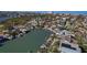 High aerial view of a waterfront home, dock and canal, with many nearby homes and community at 1101 Bay Pine Blvd, Indian Rocks Beach, FL 33785