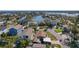 Stunning aerial view of a waterfront property with a private dock, pool, and lush landscaping in a coastal community at 1101 Bay Pine Blvd, Indian Rocks Beach, FL 33785