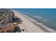 Scenic aerial perspective showcasing a beautiful beach, with beachfront condos, a pool, and calming ocean waves at 1101 Bay Pine Blvd, Indian Rocks Beach, FL 33785