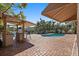 Expansive backyard featuring a pool, grill, and lush landscaping, perfect for outdoor living and relaxation at 1101 Bay Pine Blvd, Indian Rocks Beach, FL 33785