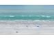 Lovely aerial shot of a relaxing beach with sandy shore and calm blue ocean waves at 1101 Bay Pine Blvd, Indian Rocks Beach, FL 33785