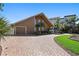 Charming two-story home with a brick driveway, attached garage, and lush tropical landscaping at 1101 Bay Pine Blvd, Indian Rocks Beach, FL 33785