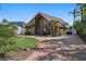 Landscaped two-story home featuring a winding brick driveway and tropical accents at 1101 Bay Pine Blvd, Indian Rocks Beach, FL 33785