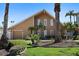 A striking two-story home featuring a well-manicured lawn, mature palms, and a two-car garage at 1101 Bay Pine Blvd, Indian Rocks Beach, FL 33785