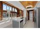 Open-concept kitchen boasts stainless appliances, quartz counters, wood ceiling accents, and pool views at 1101 Bay Pine Blvd, Indian Rocks Beach, FL 33785