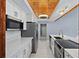 Well-lit kitchen featuring stainless steel appliances, white cabinetry, and quartz countertops at 1101 Bay Pine Blvd, Indian Rocks Beach, FL 33785