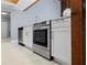 Kitchen area with stainless steel oven, white cabinetry, and quartz countertops at 1101 Bay Pine Blvd, Indian Rocks Beach, FL 33785